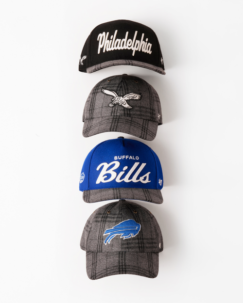 Four baseball caps with different team logos on a white background