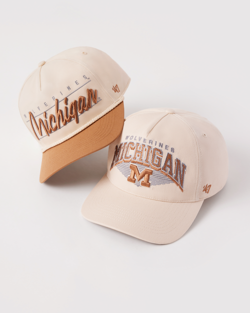 Two beige caps with 'Michigan' text on a white background