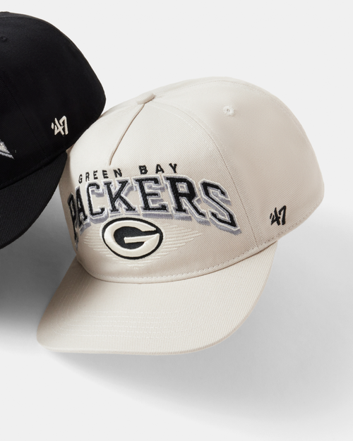 Two baseball caps, one black and one beige with 'Green Bay Packers' text, on a light gray background.