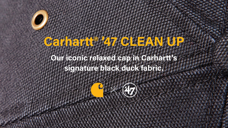 Close-up of Carhartt '47 Clean Up cap with brand logos and text on black duck fabric. CARHARTT '47 CLEAN UP- OUR ICONIC RELAXED CAP IN CARHARTTS SIGNATURE BLACK DUCK FABRIC