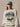 Person wearing a Philadelphia Eagles sweatshirt and cap against a neutral background