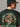 Person wearing a green 'Miami Hurricanes' t-shirt with a football player graphic.