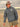 A man on the beach wearing a Chicago Cubs sweatshirt