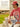 Image of a man sitting in front of a house, wearing a red Boston Red Sox short sleeve T-shirt, and a red cleanup Boston Red Sox hat. Perfectly weathered colors and trademark comfort give these timeless styles, classic coastal charm for MLB and NCAA
