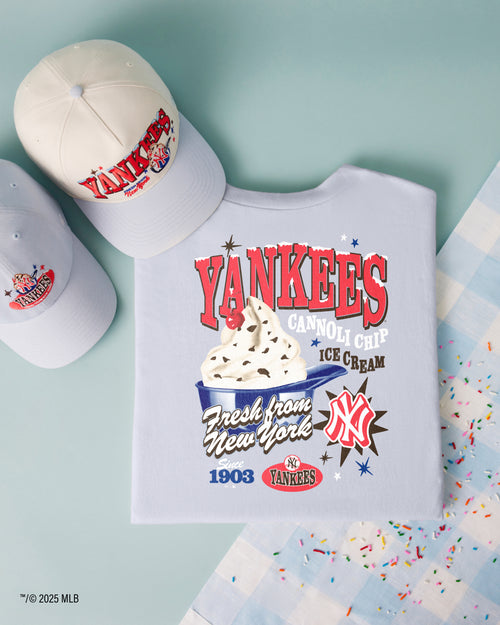 Yankees-themed t-shirt with ice cream graphic and two caps on a light blue background