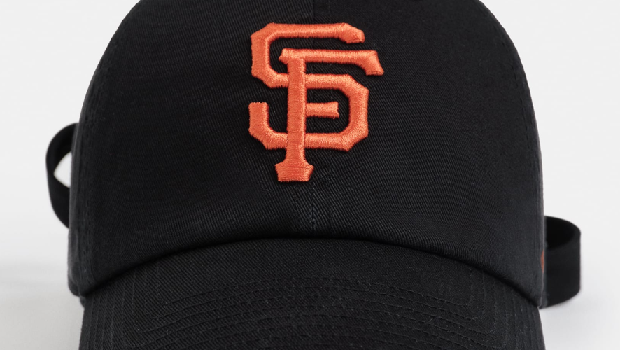 black madhappy hat with orange embroidered logo