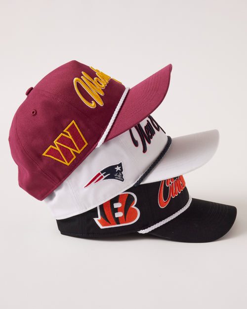 Three baseball caps with different logos on a white background