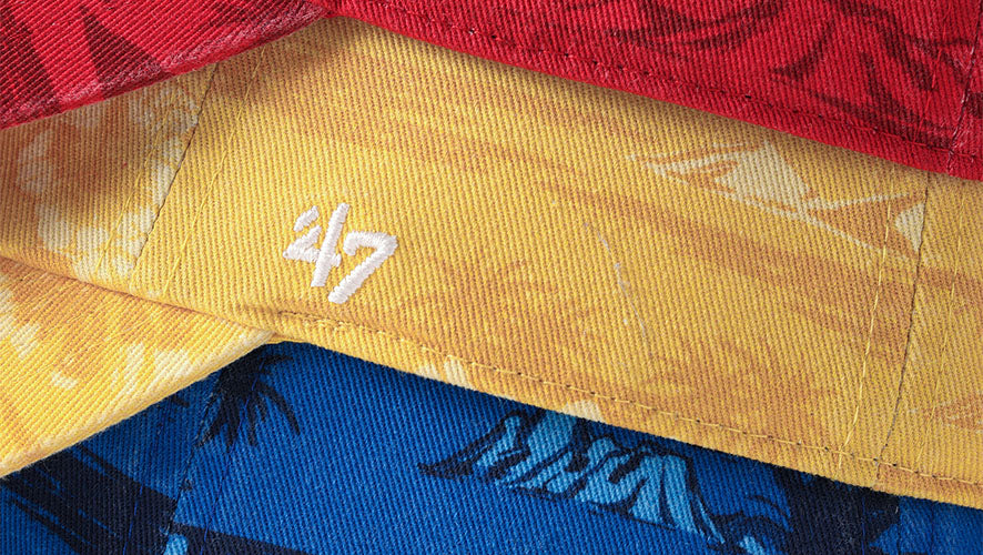 three side angle of hats close up (blue, yellow and red with Fiji details)
