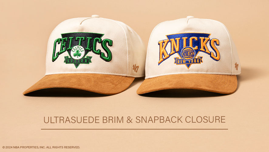 Side-by-side display of Celtics and Knicks Triangle '47 Hitch hats with ultrasuede brims and bold embroidered logos on a tan background.