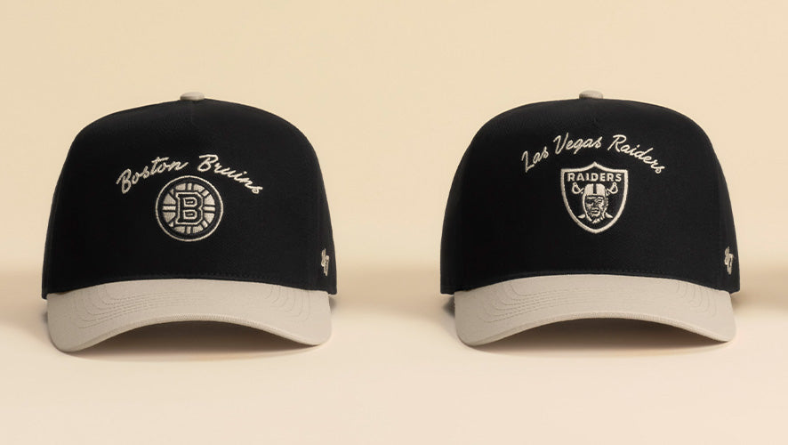 two black and cream hats on a cream background.