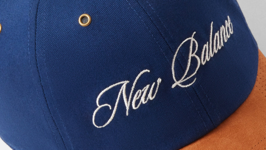 Blue cap with 'New Balance' embroidery on a gray background