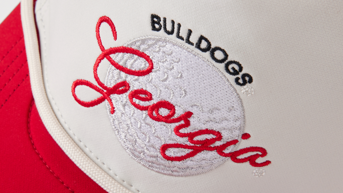GEORGIA BULLDOGS embroidery and golf ball on front of a hat.