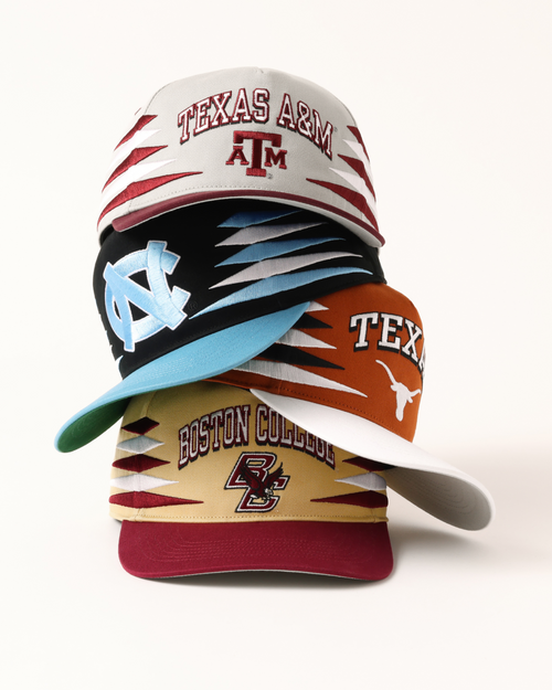 A stack of diamond cut hats- Texas A&M, UNC, Texas, BC.