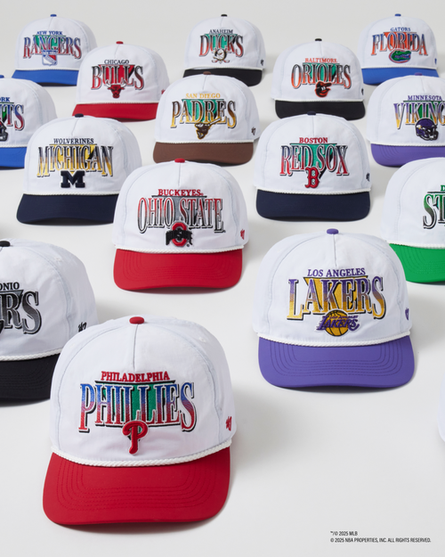 Collection of sports team-themed baseball caps on a white background