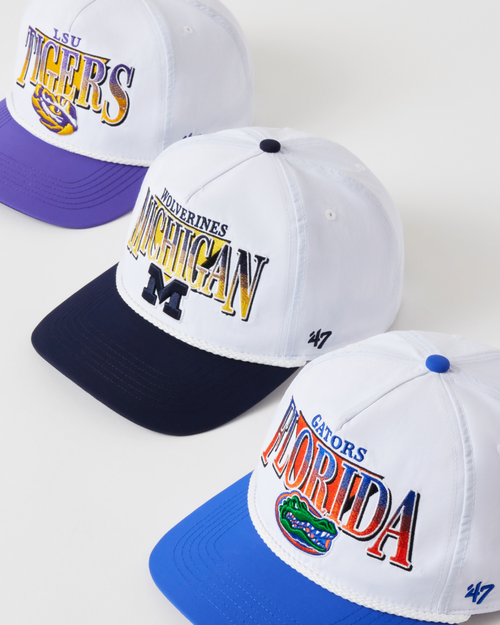 Three sports-themed caps with visible brand logos on a white background