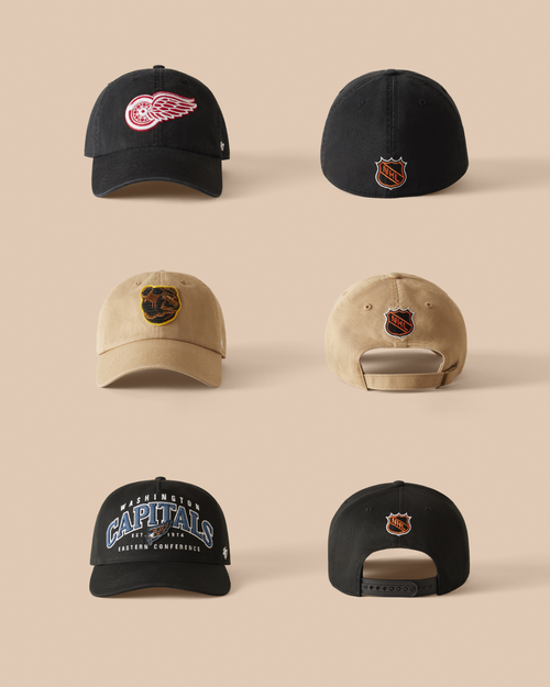 Collection of baseball caps with various logos on a beige background