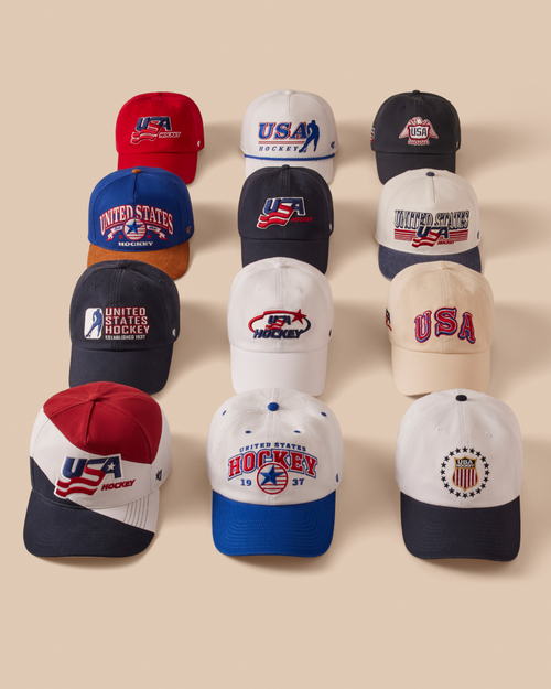 Collection of USA hockey-themed baseball caps on a beige background