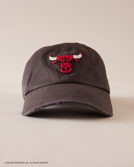 DARK GRAY CAP WITH RED AND WHITE LOGO ON A BEIGE BACKGROUND