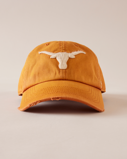 Orange cap with a white logo on a beige background