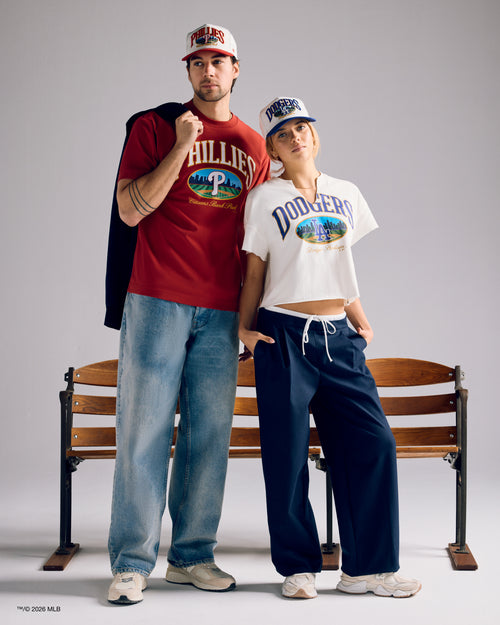 a man and woman in opening day apparel and headwear.