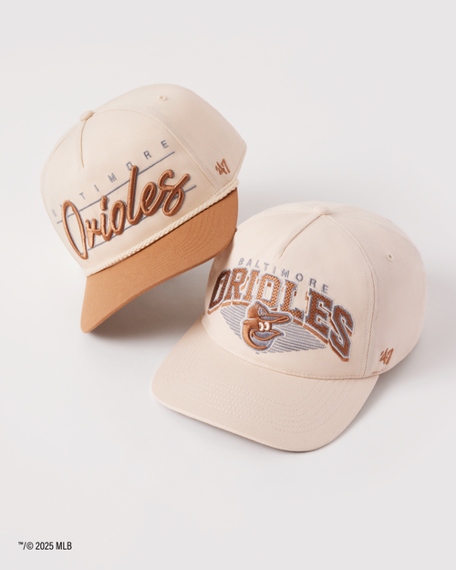 Two Baltimore Orioles baseball caps on a white background