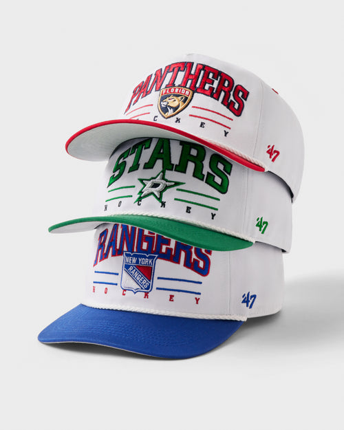 Three sports team caps from different teams on a white background