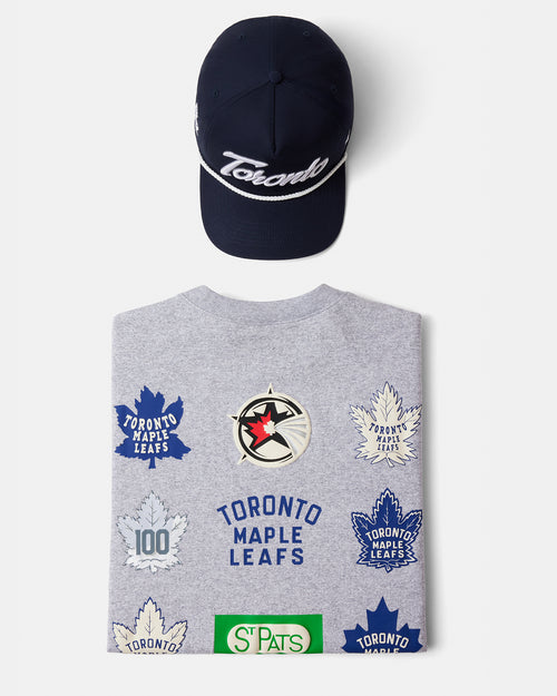 Gray sweatshirt with Toronto Maple Leafs logos and a navy cap on a white background
