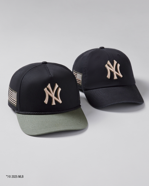 Two black baseball caps with a logo on a light gray background