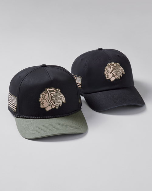 Two black baseball caps with logos on a light gray background