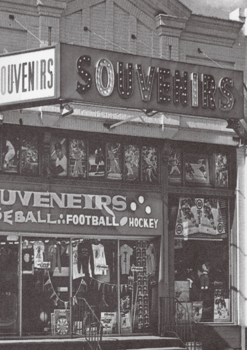 Vintage store front with 'Souvenirs' sign and sports-themed merchandise.