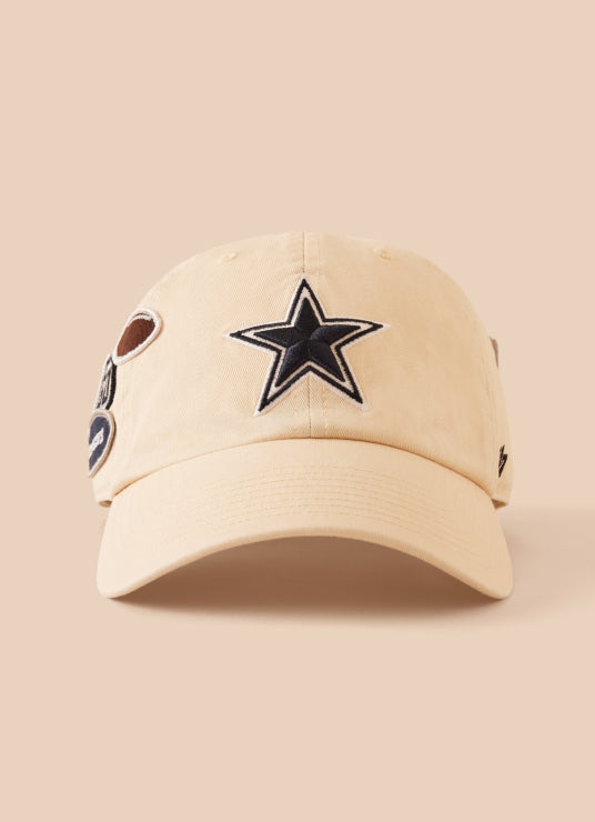 Beige cap with star logo and patches on a beige background