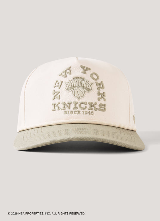 Beige cap with 'New York Knicks' text on a light gray background
