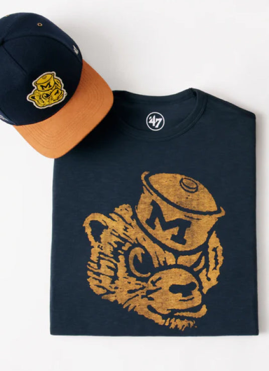 Navy blue t-shirt with gold logo and matching cap on a white background