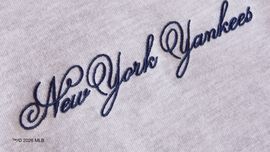 Embroidered 'New York Yankees' logo on a gray mock neck sweatshirt