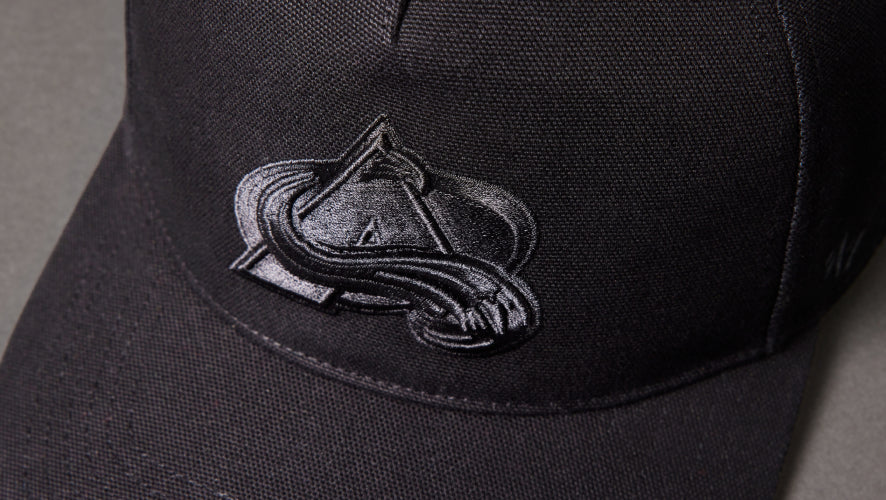 Black cap with a logo on a gray background