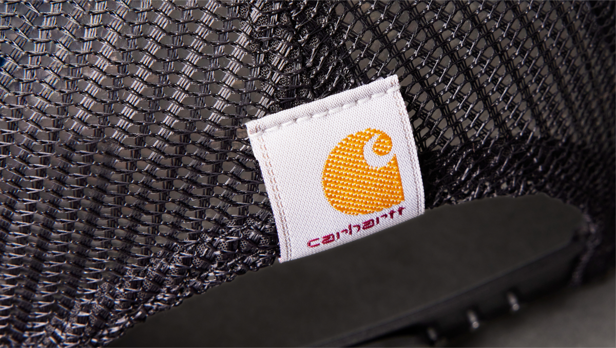 Close-up of a Carhartt logo on a textured surface