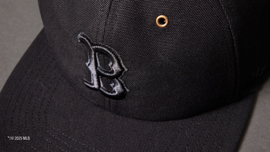 Black cap with a logo on a dark background