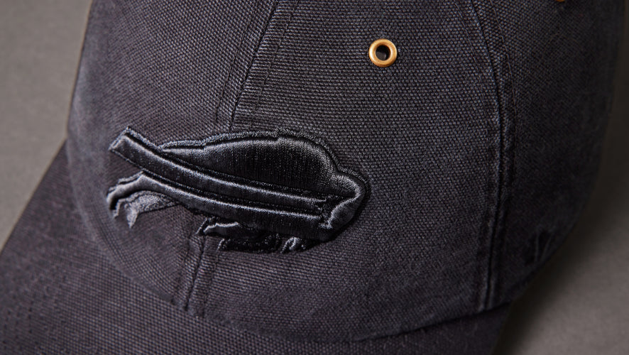 Black cap with a logo on a dark background