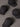 Four black baseball caps with logos on a gray background