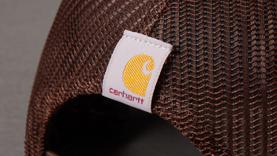 Brown mesh cap with Carhartt logo on a gray background
