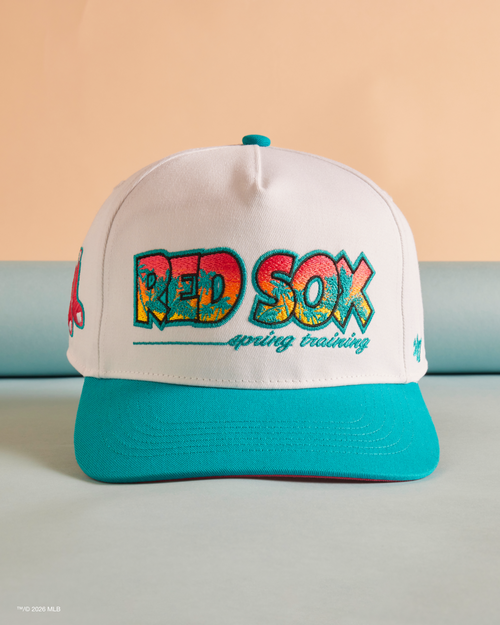 White and teal baseball cap with 'Red Sox' text on a beige background