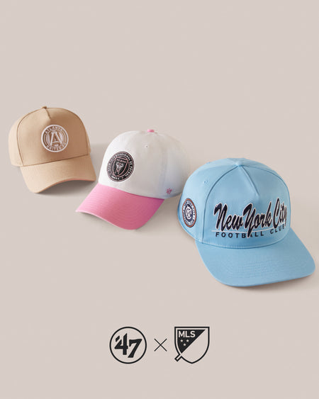 THREE BASEBALL CAPS IN BEIGE, PINK, AND BLUE WITH LOGOS ON A LIGHT GRAY BACKGROUND.