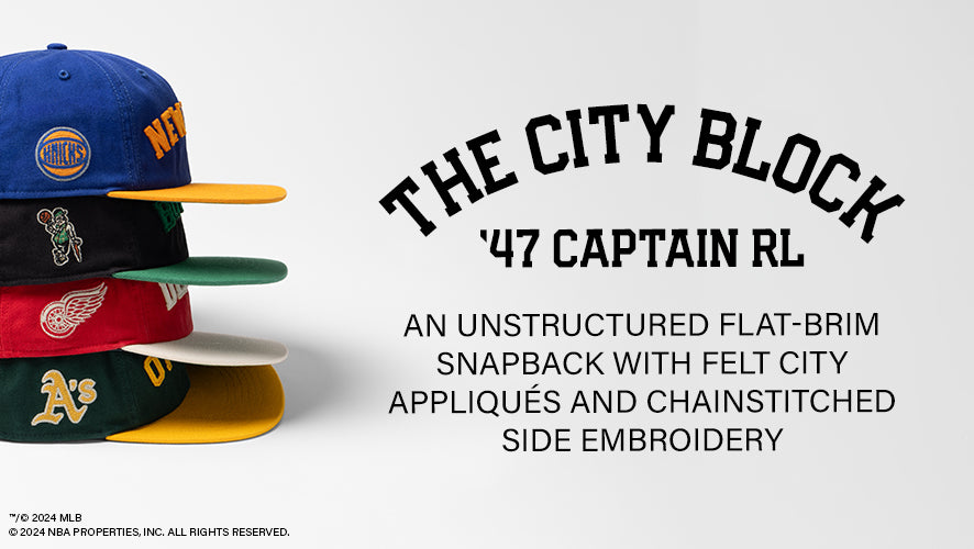 The City Block '47 Captain RL. An unstructured flat-brim snapback with felt city appliques and chainstitched side embroidery.