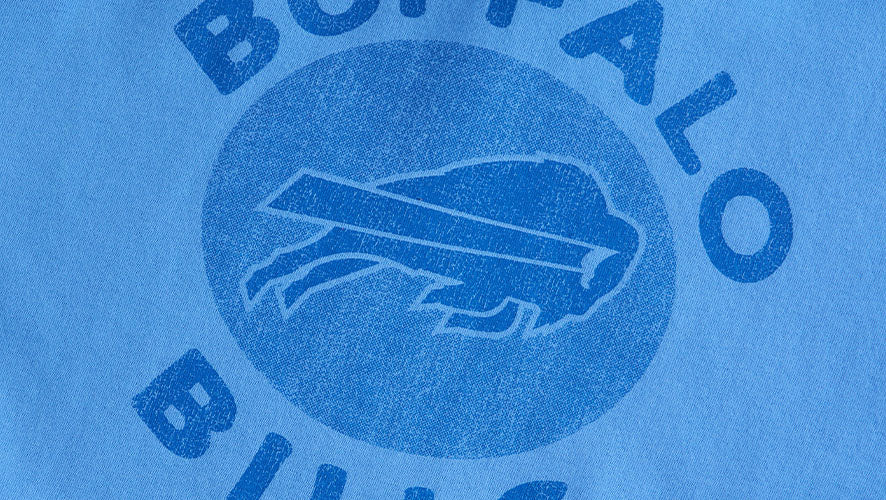 Washed blue background with distressed Buffalo Bills circle logo featuring a charging buffalo.