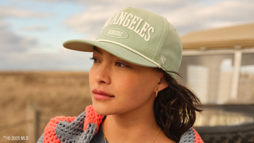 Woman with a light green Dodgers hat on. 