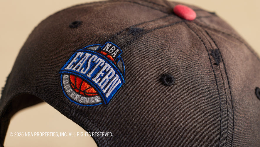 Gray cap with NBA Eastern Conference logo on a beige background