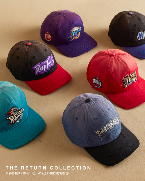 Collection of sports team-themed baseball caps on a beige background. The Return Collection