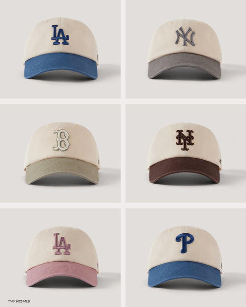 Six baseball caps with different team logos on a light gray background