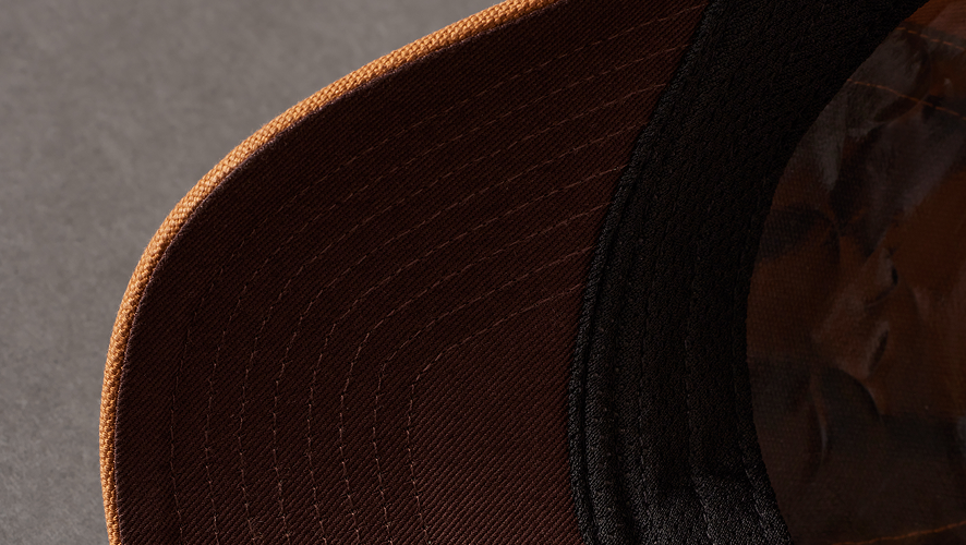 detailed image of the brim of a carhartt hat  
