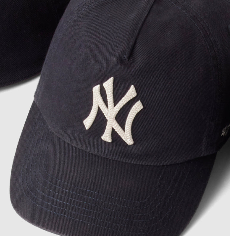 Black cap with white logo on a light gray background